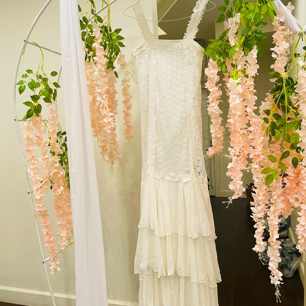 A beautiful white dress, size 36, new with tags.